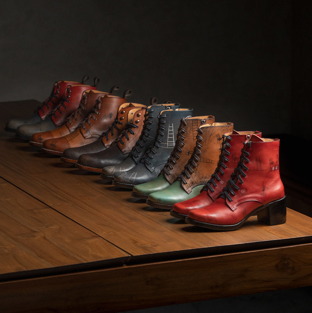 Row of colorful leather boots on a wooden surface with a dark background